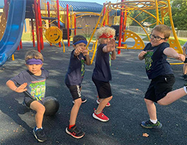 Students on playground posing in action shots