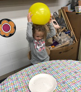 Little girl playing with a balloon